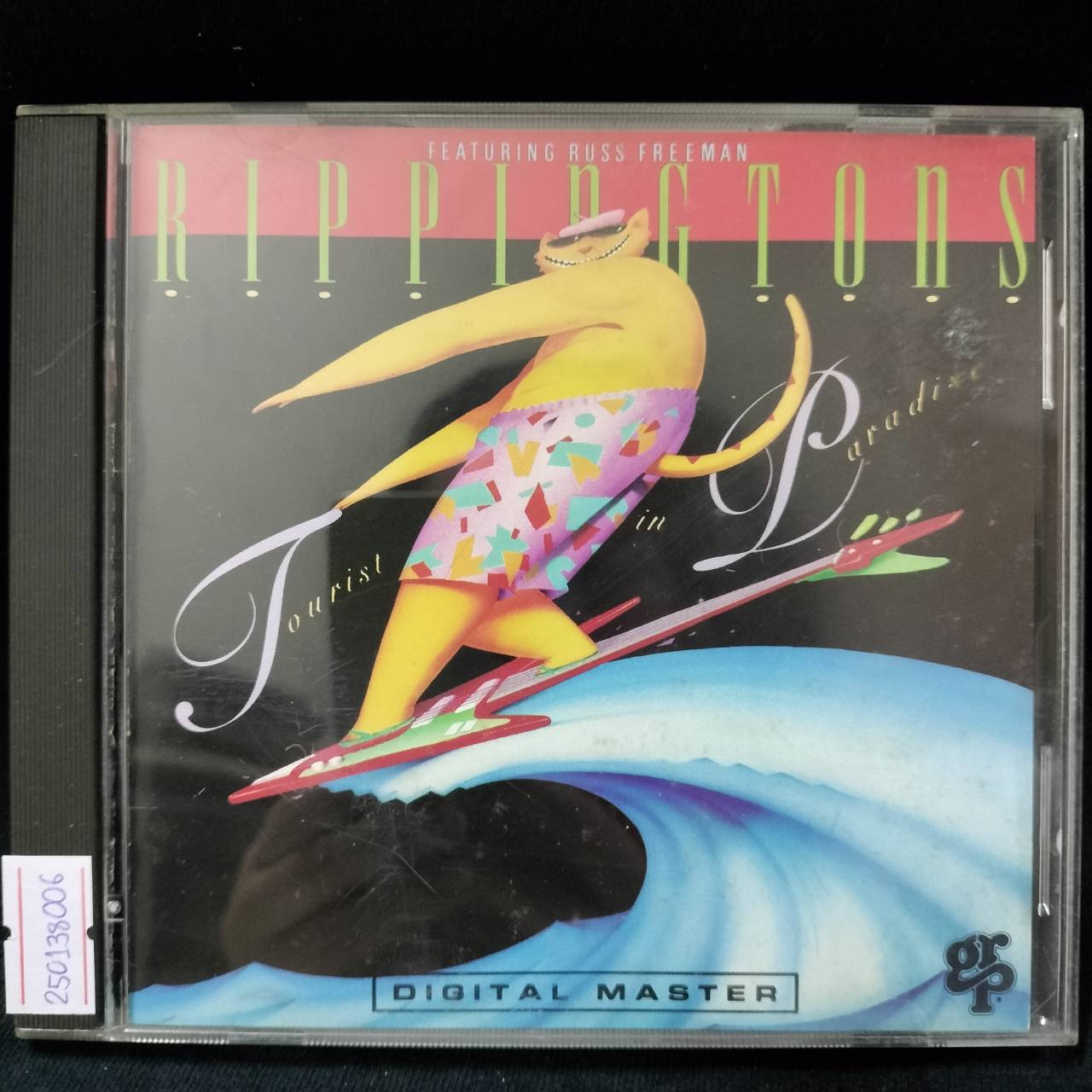 The Rippingtons Featuring Russ Freeman – Tourist In Paradise / USA / ปกมีจุดเหลือง / มีรอยบ้าง